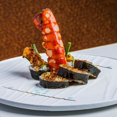 Lobster Roll served with a striking, cooked lobster tail.