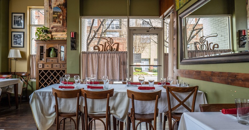 Dining table with glasses and accessories near the entrance door