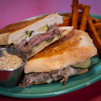 Cuban Panini, with pulled pork, ham, Swiss, pickles, and sweet potato fries.