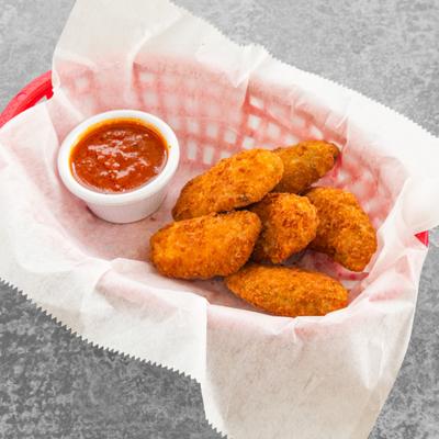 Fried chicken bites served with dipping sauce.