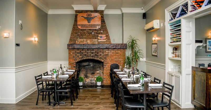 Interior, tables set up for a diner, fireplace behind