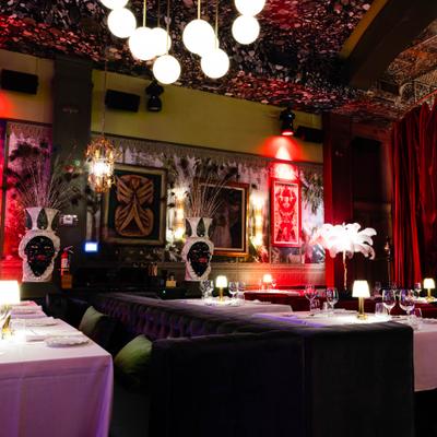 Dining room interior with artwork and lighting fixtures.