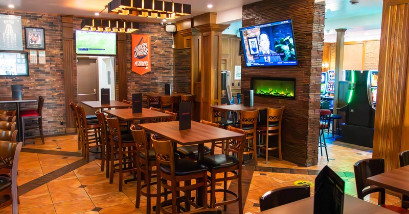 Inside, tables, chairs, TVs, an electric fireplace and arcade machines