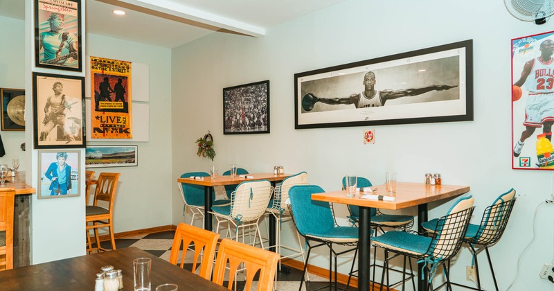 Interior, seating area, bar tables and stools, pictures on the walls