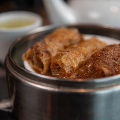 Tofu skin rolls in a steamer basket.