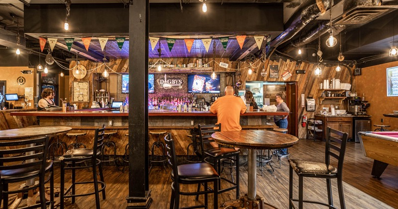 Interior, tables and chairs, bar in the back