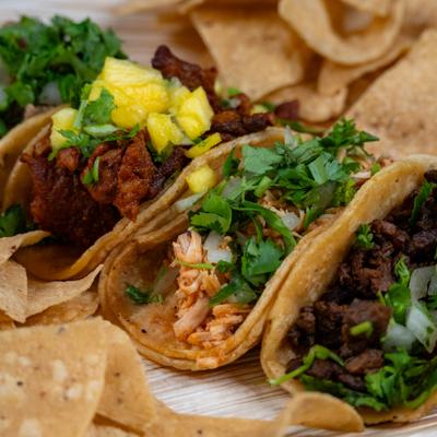 Three tacos, close up.