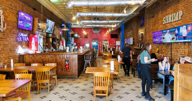 Interior space, bar area, and dining area with guests ordering their food