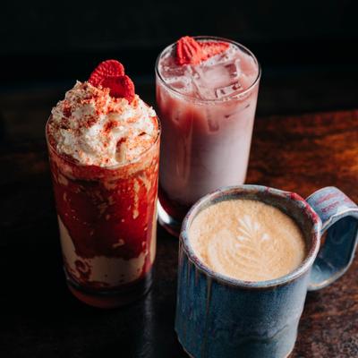 Three specialty beverages including latte and strawberry drinks.