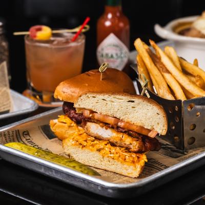 Grilled chicken sandwich, with applewood smoked bacon, mango chutney mayo, and fries.