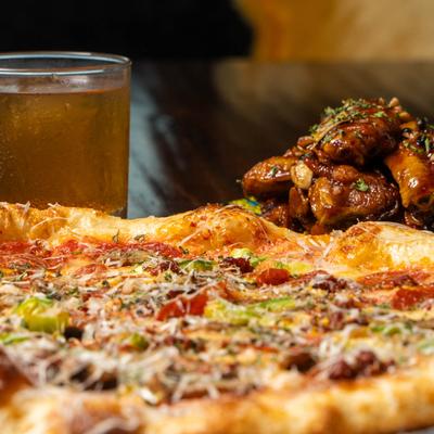 Pizza with chicken wings and a drink.
