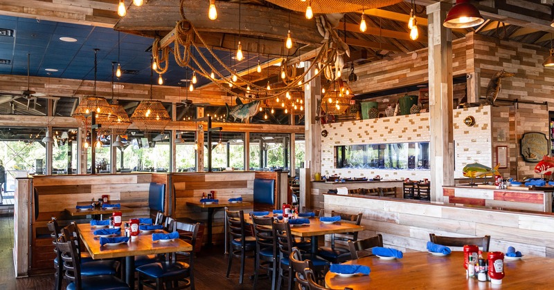 Interior, tables with tableware and chairs