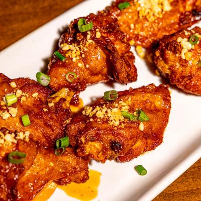 Chicken wings garnished with green onions.