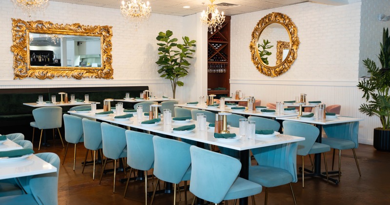 Interior, open space dining area, long table setups for twelve people, banquette seating