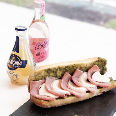 Sandwich with salami, pesto, and mozzarella.