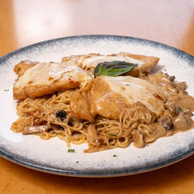 Spaghetti with breaded chicken and creamy mushroom sauce.