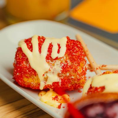 Elote topped with powdered chili and creamy sauce.