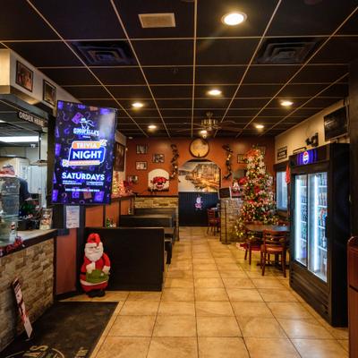 Interior with booth seating, counter, holyday decorations and display refrigerator.