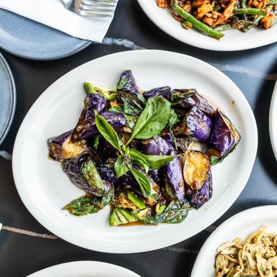 Stir-fried Thai purple eggplant with mixed soy sauce, jalapenos, and Thai basil.