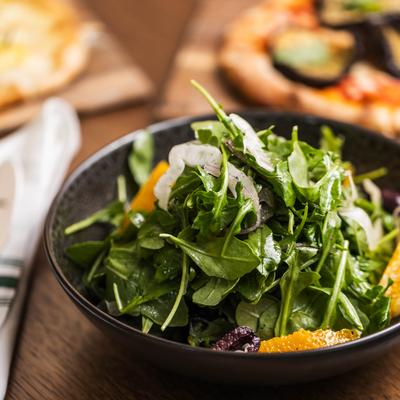 Salad with fennel, baby arugula, orange, olives, and pickled red onion.
