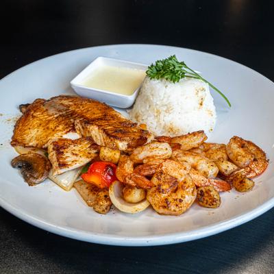 Grilled tilapia, scallops and shrimp, with grilled onions, peppers, rice, and dipping sauce.