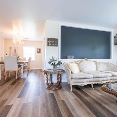Wedding suite with vintage furniture, flowers, and a large blackboard on a wall.