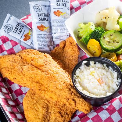 Fried chicken , onions, tartar sauce bags and a veggies bowl on a  tray, top view