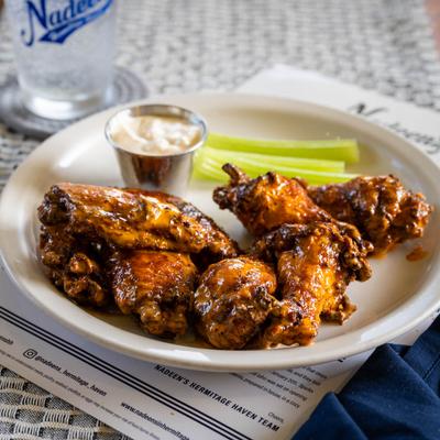 Buffalo wings served with celery sticks and ranch dressing.