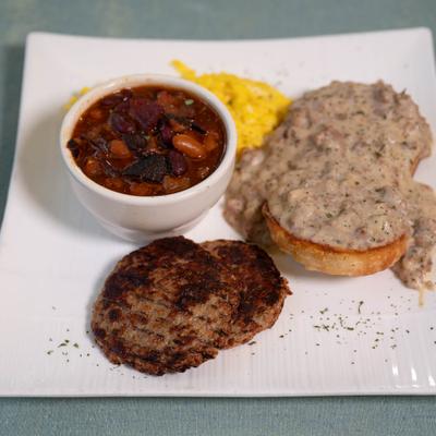 Biscuits and gravy with sausage patties.