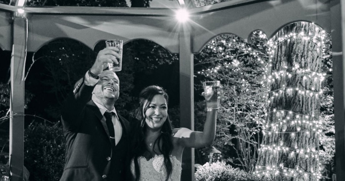 Bride and groom raising glasses