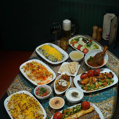 Various dishes served on a table, side view.