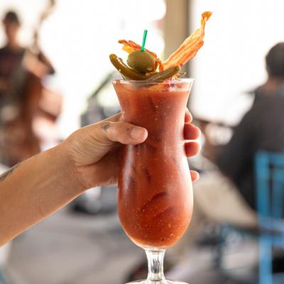 Hand holding a glass of Bloody Mary