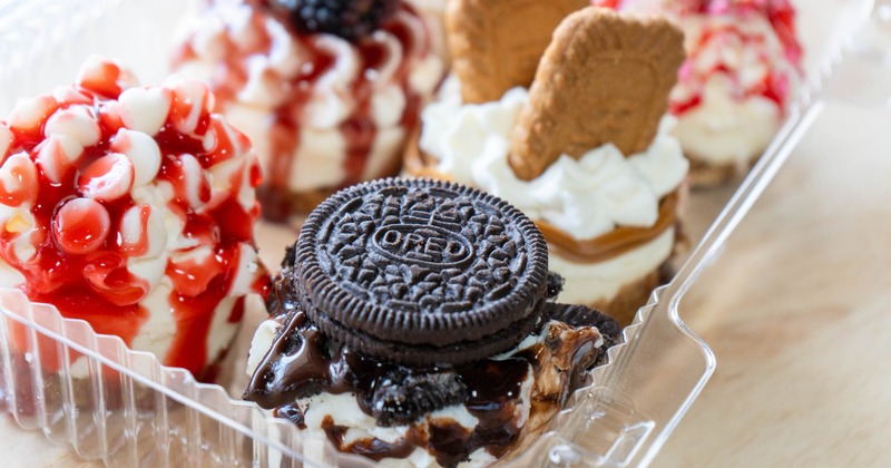 Assorted mini cheesecakes featuring various toppings, close-up