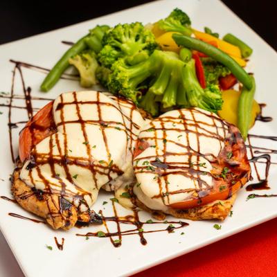 Chicken caprese sandwich with balsamic drizzle and a side of mixed vegetables