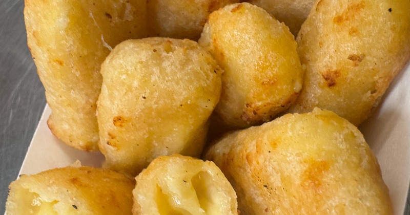 Fried cheese bites served in a paper tray