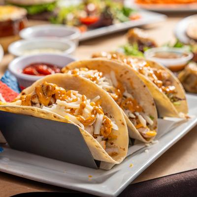 Chicken tacos, with cheeses, lettuce, tomatoes and cajun ranch drizzle.