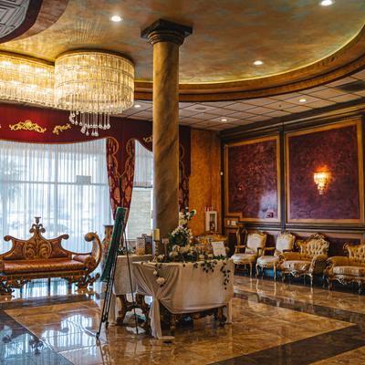 Royal Palace lobby, lavish seating, gift table.