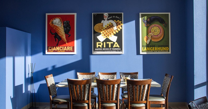 Interior, tables and chairs, framed pictures on the wall