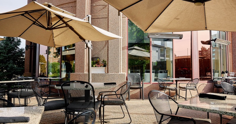 Exterior, patio, partially covered seating area, tables with chairs, ready for guests