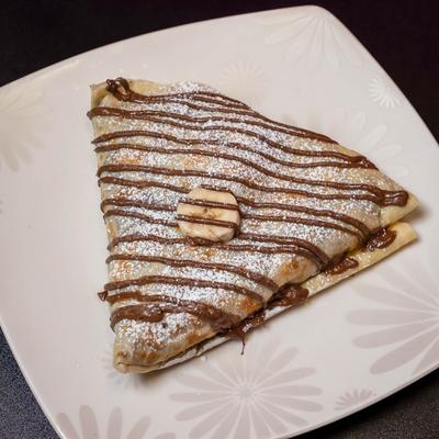Crepe with Nutella, banana, and powdered sugar.