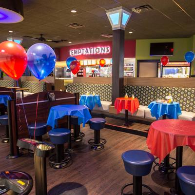 Restaurant interior set with blue and red party tables and colorful balloons.