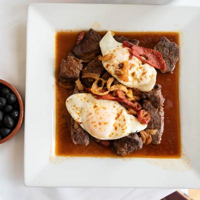 Azores-style tenderloin steak drenched in pan sauce and topped with fried eggs.