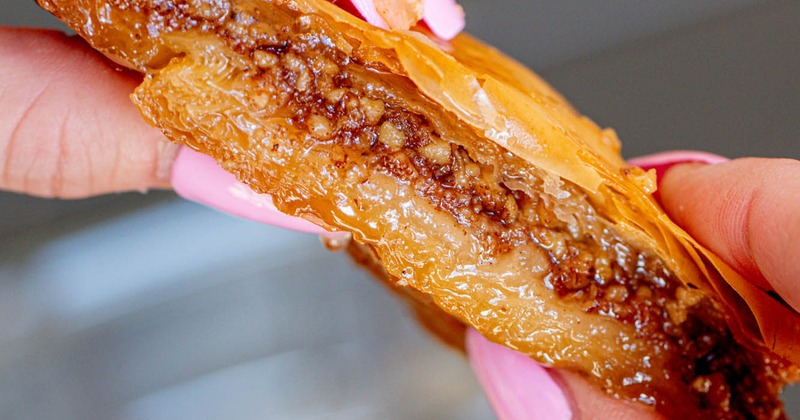 Baklava in hands, close up