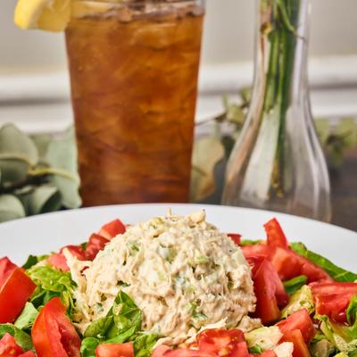 Chicken Salad featuring a large scoop of rotisserie chicken salad and fresh vegetables.