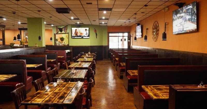Interior, lined up tables, chairs and high back benches ready for guests
