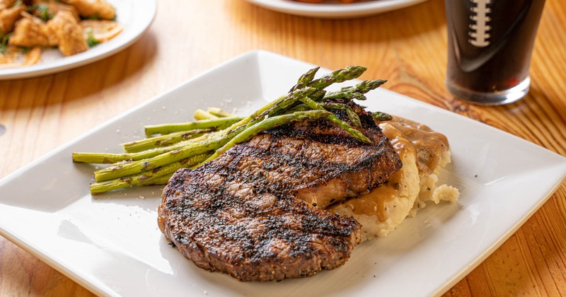 Rib eye steak with gravy mashed potatoes and asparagus