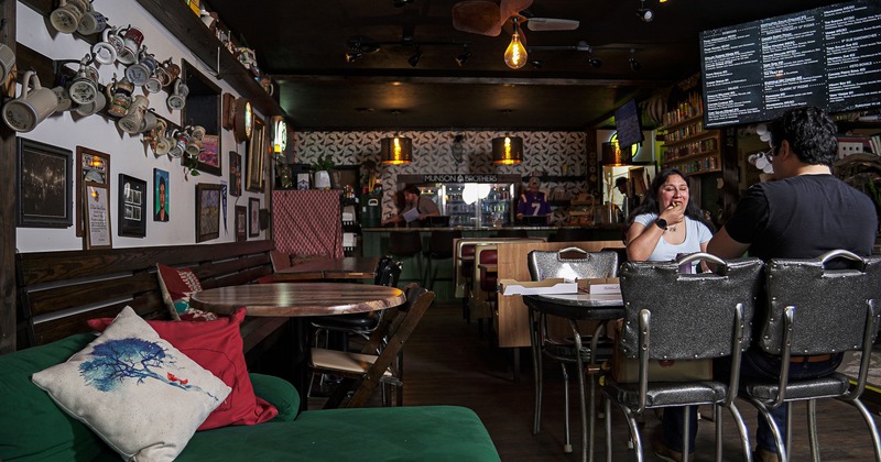 Cozy and rustic interior seating area with two guests enjoying their food