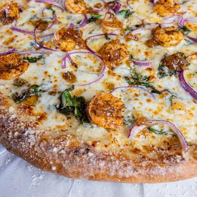 Shrimp pizza with red onions and melted cheese