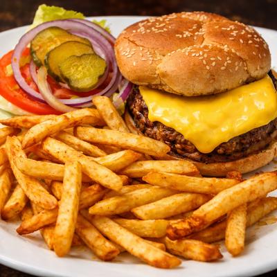 Cheeseburger served with fries.