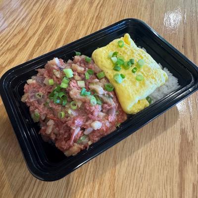 Rice dish with raw tuna and egg omelet.